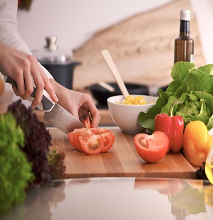 woman cutting up tomatos