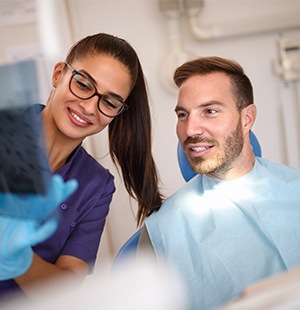 assistant showing man x-rays