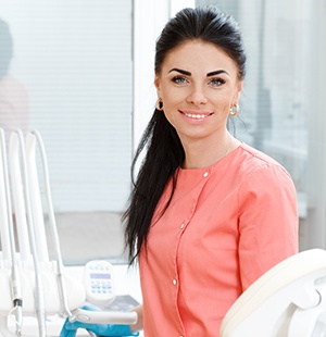 woman in coral smiling