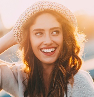 woman smiling with sunlight behind her