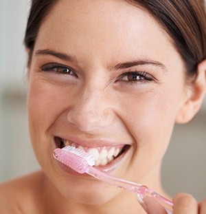 woman brushing teeth