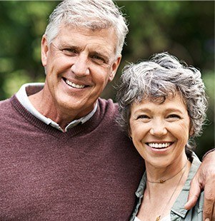 husband and wife hugging and smiling