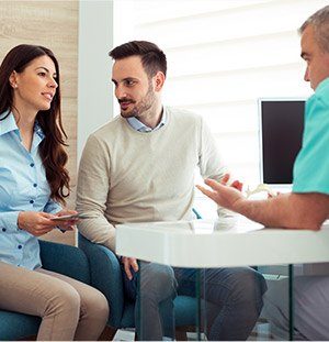 couple talking to dentist