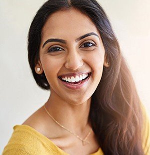 woman in yellow smiling