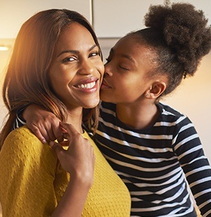 daughter kissing mother