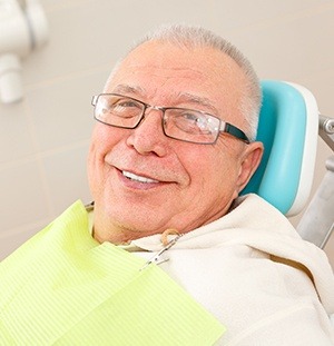 older man with glasses smiling