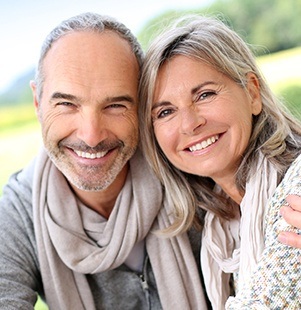 man and woman with scarves smiling