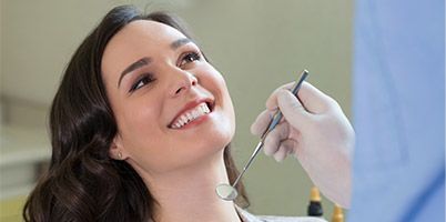 beautiful woman smiling up at dentist
