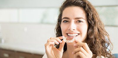 woman putting in invisalign