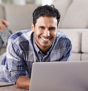 man smiling on computer