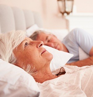 woman laying in bed awake