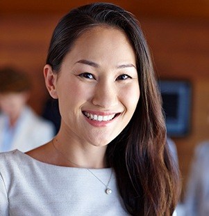 woman with light blue dress on smiling