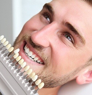 man smiling with shade chart